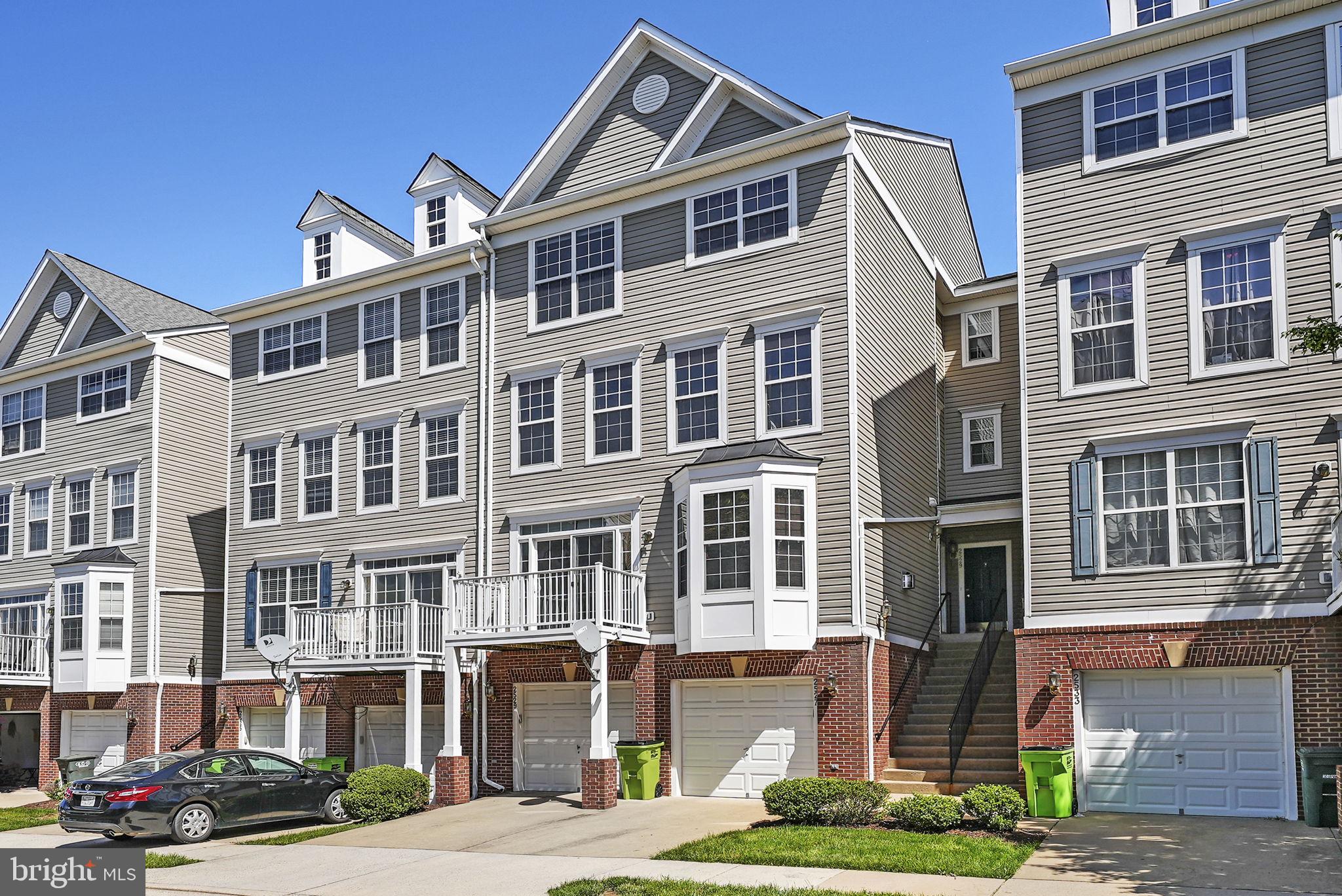 a front view of a residential apartment building with a yard