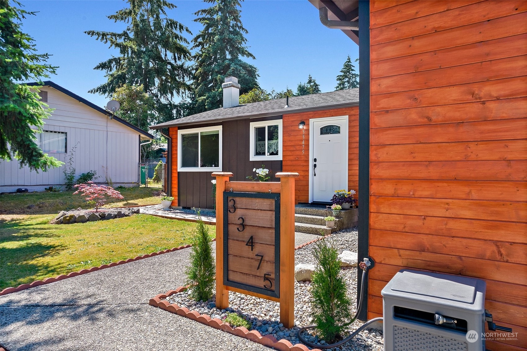 a view of a house with backyard and sitting area