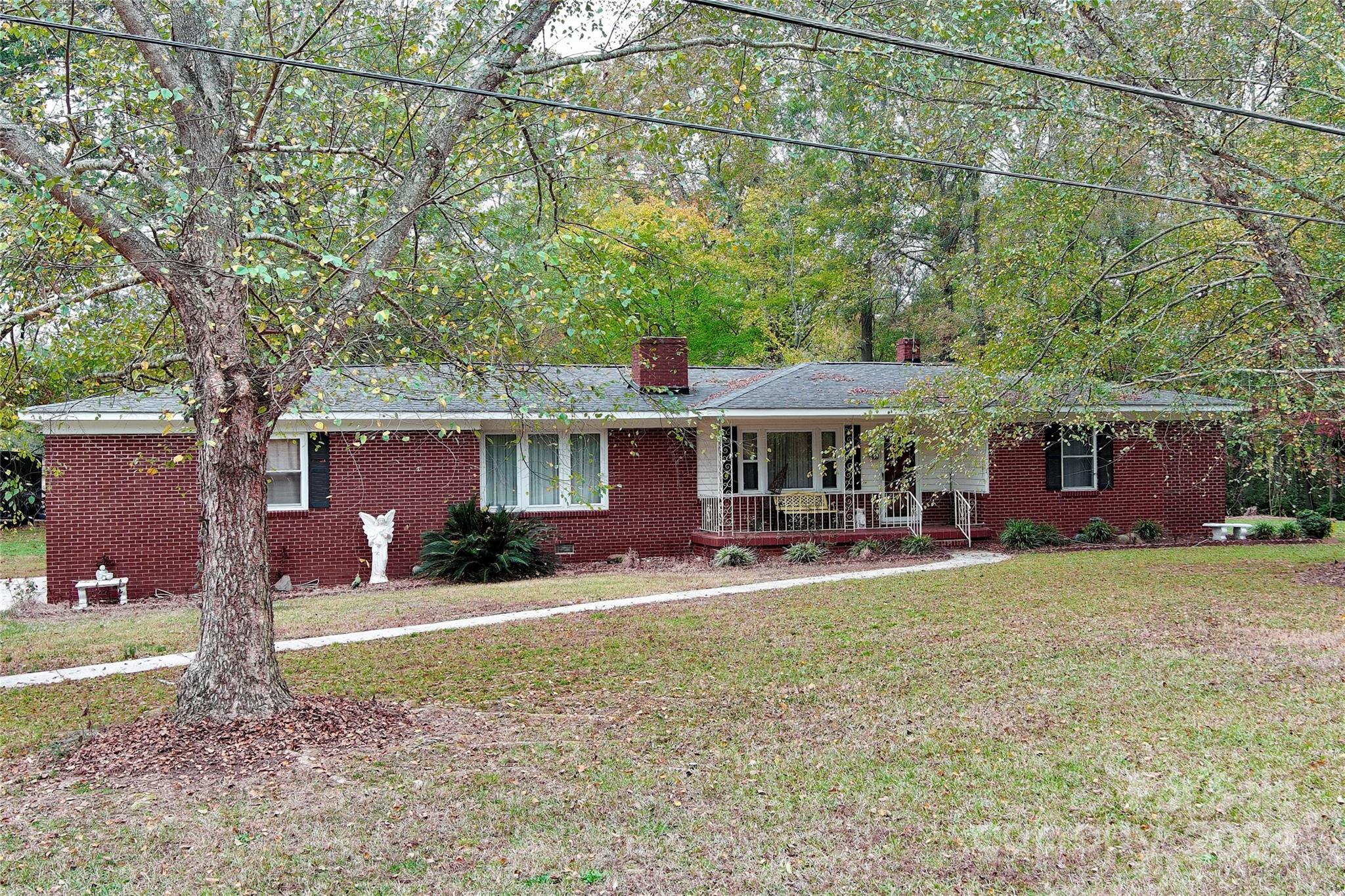 a view of a house with a yard and sitting area