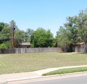 a view of a swimming pool with a yard