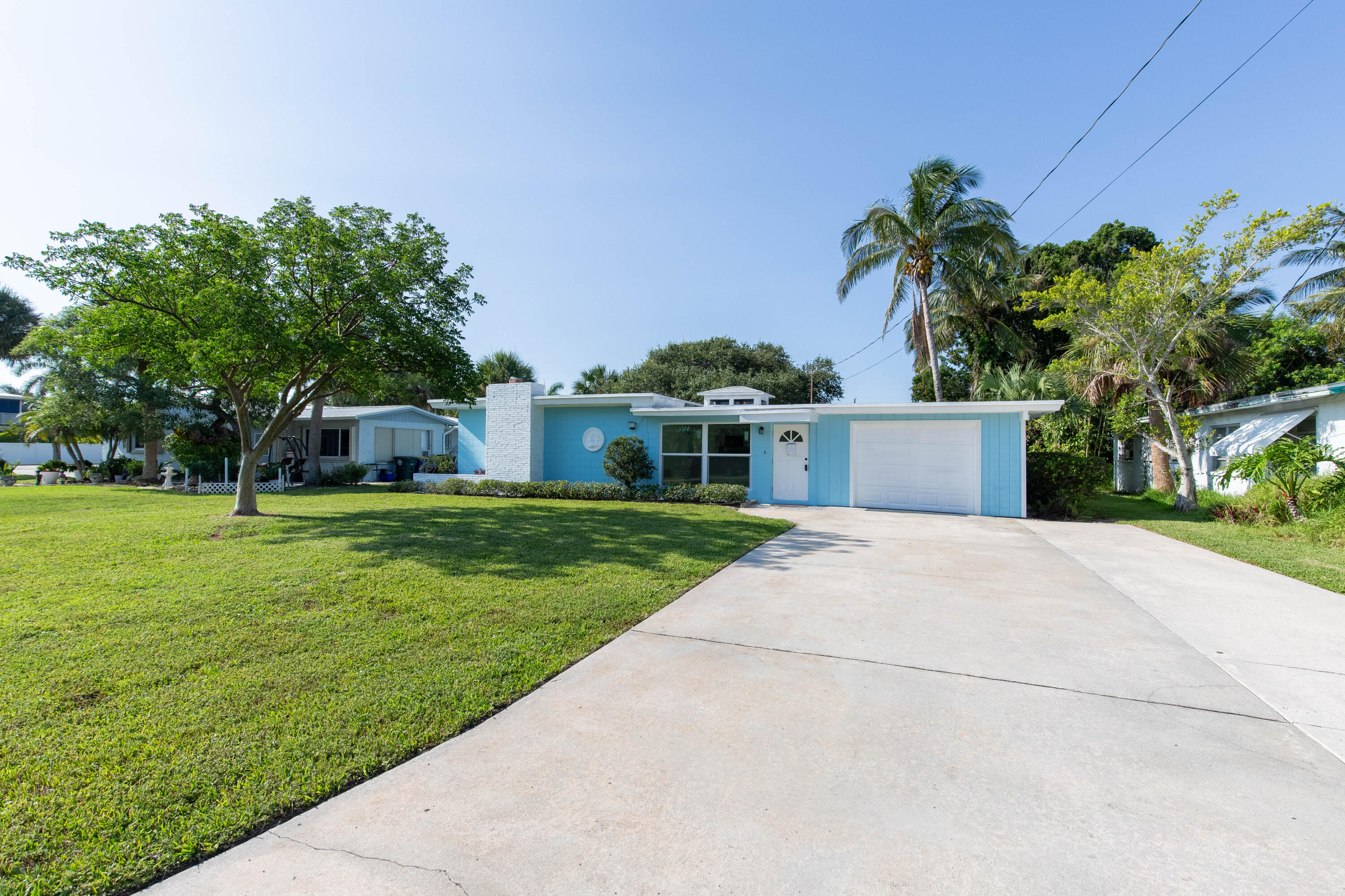 a front view of house with yard and trees