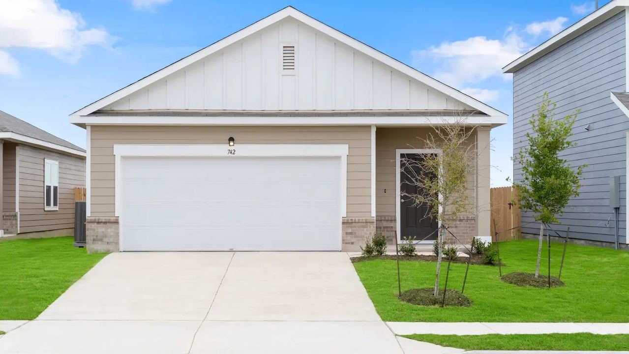 a front view of a house with a yard