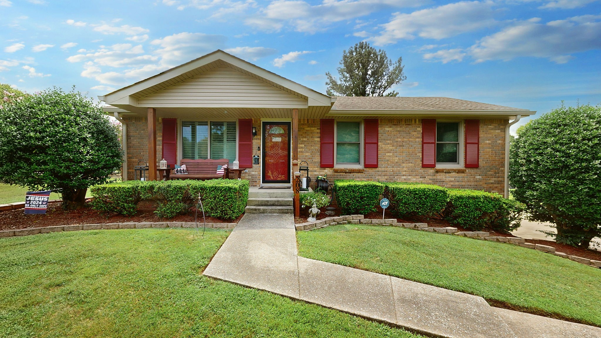 a front view of a house with a yard and porch