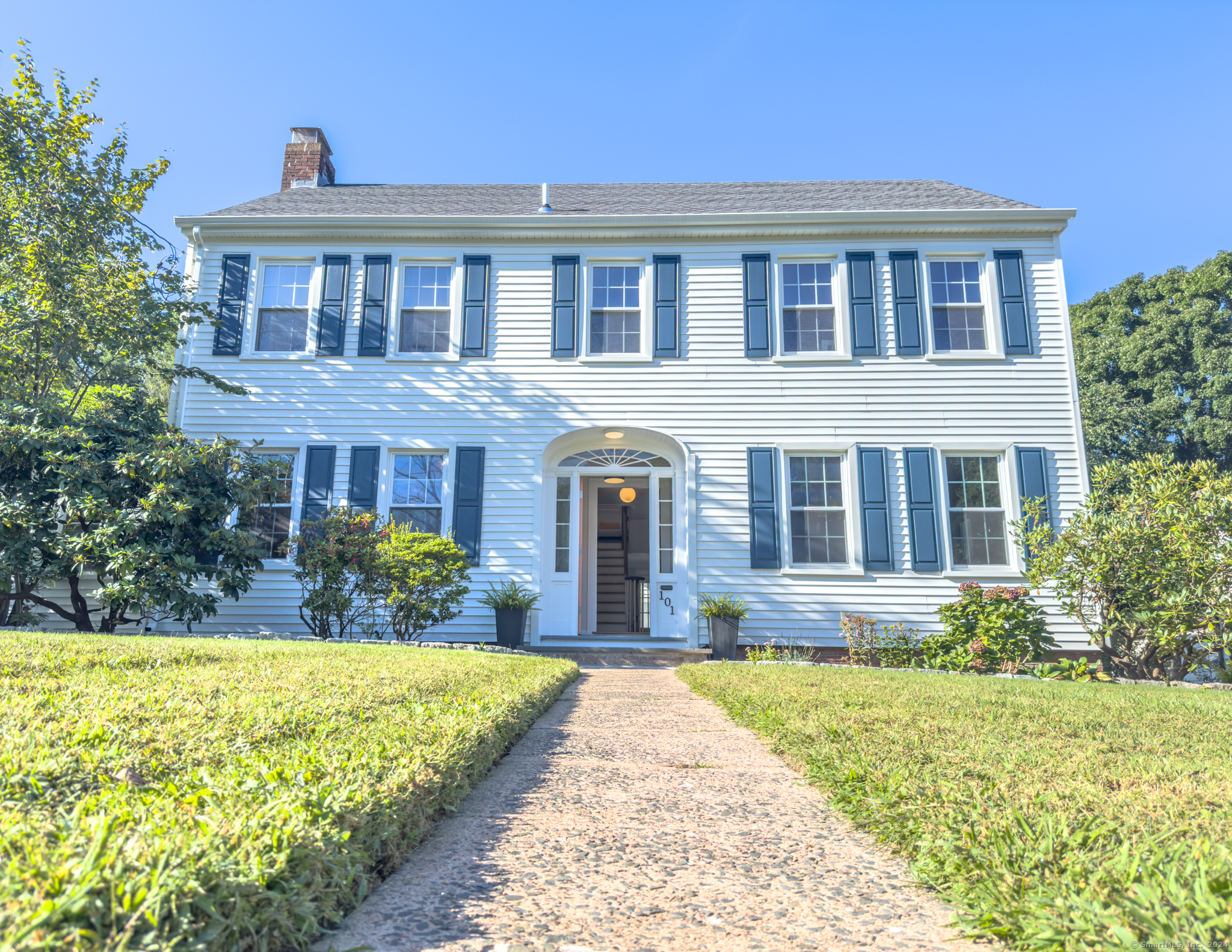 a front view of a house with garden