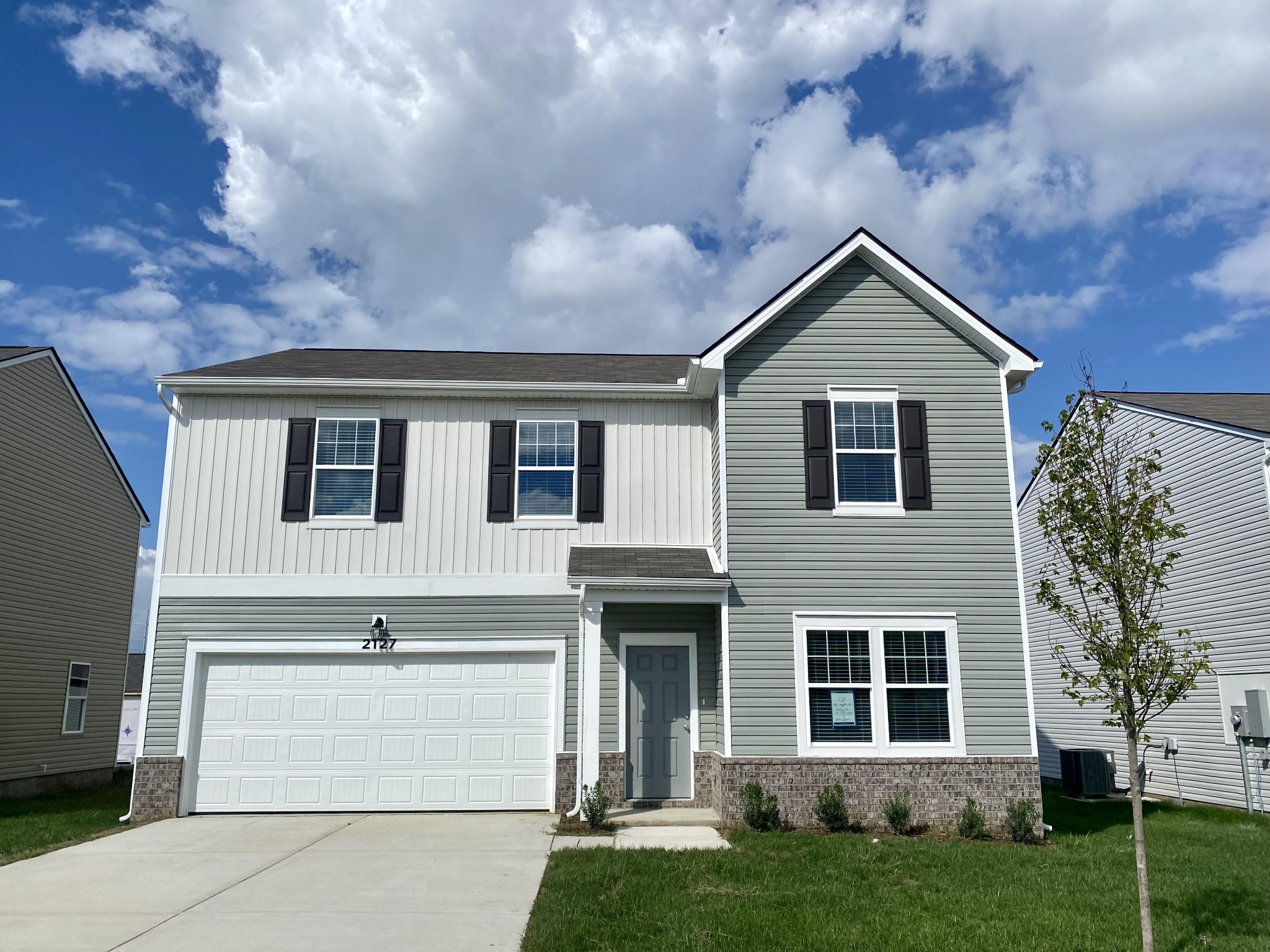 a front view of a house with a yard