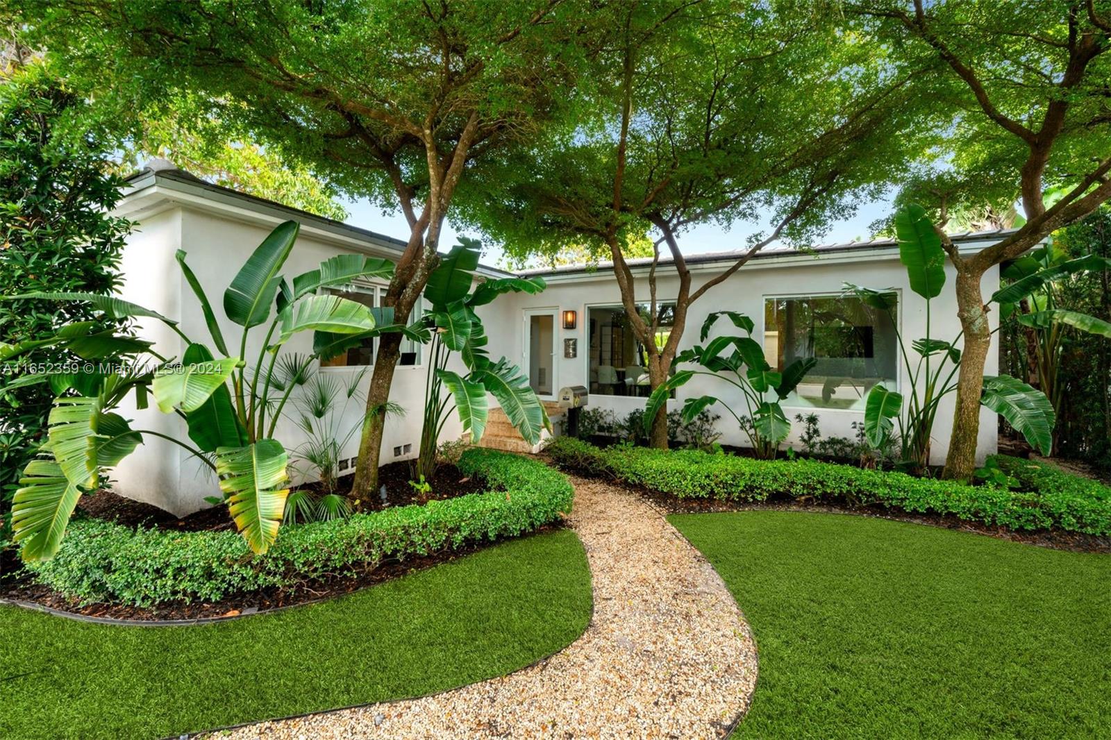 a front view of a house with a garden