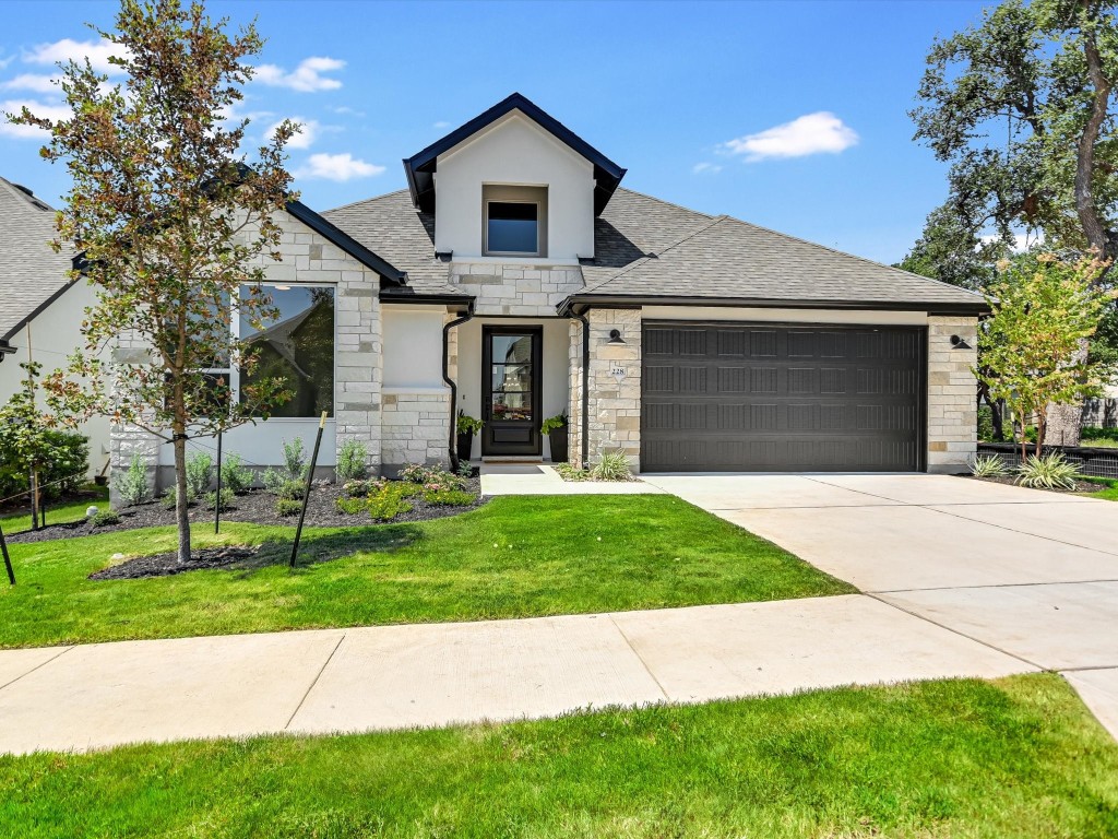 a front view of a house with a yard and garage