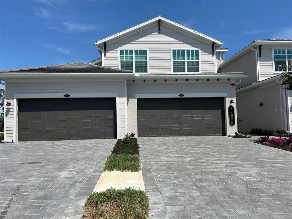 a front view of a house with a yard and garage