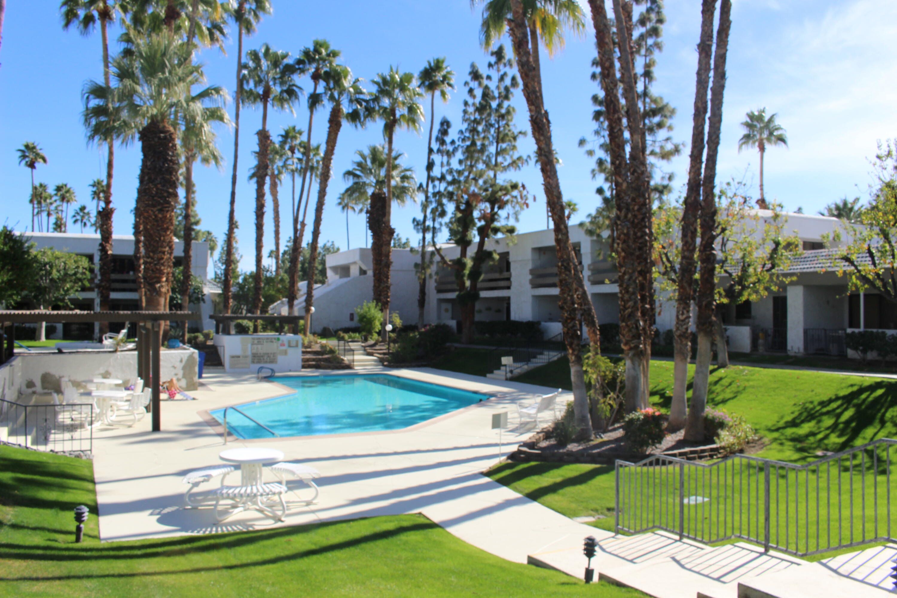 a view of a house with backyard water fountain and sitting area