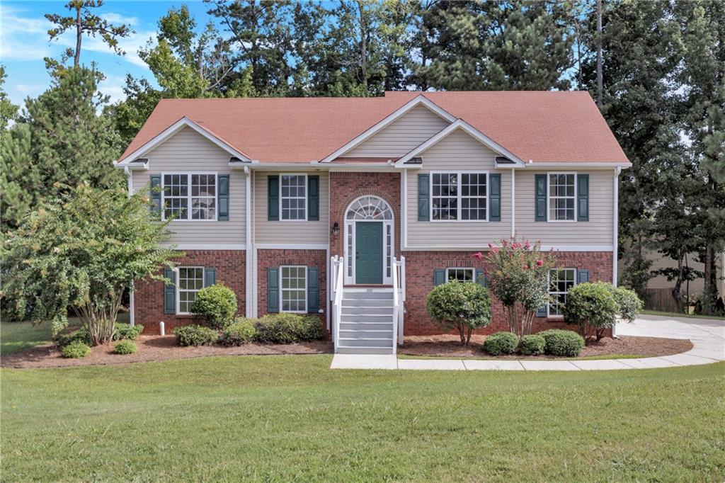 a front view of a house with a yard and garage