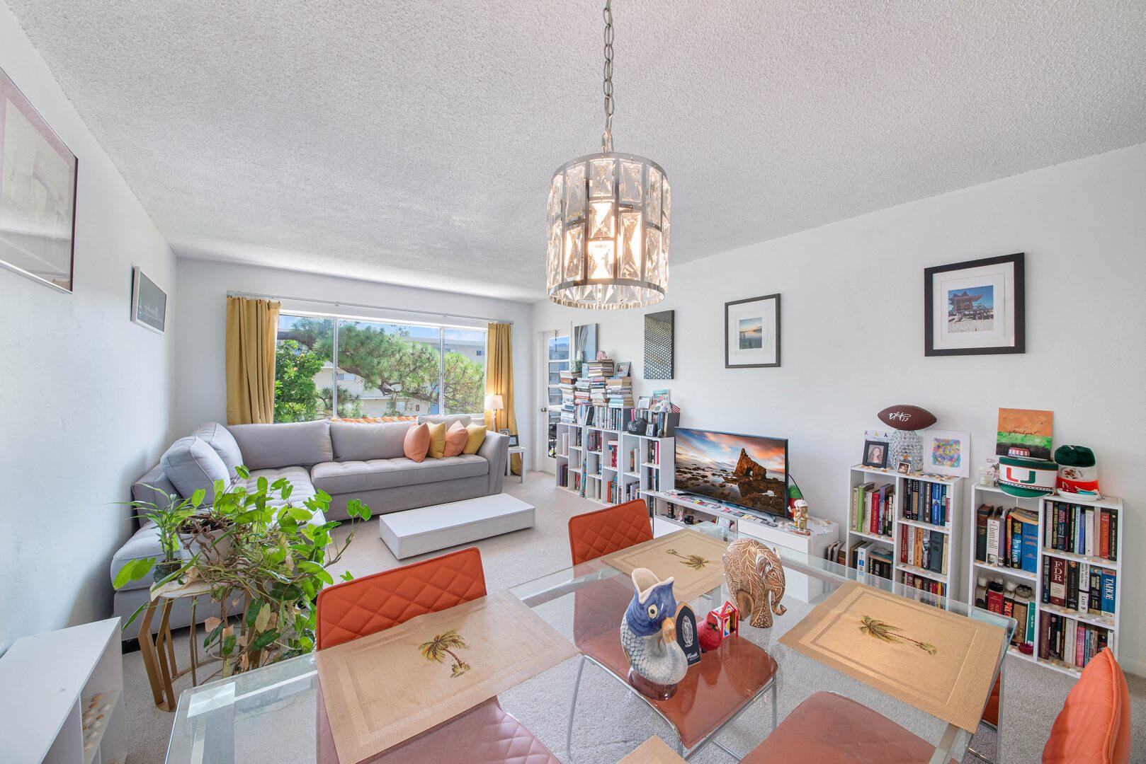 a living room with lots of furniture and a chandelier