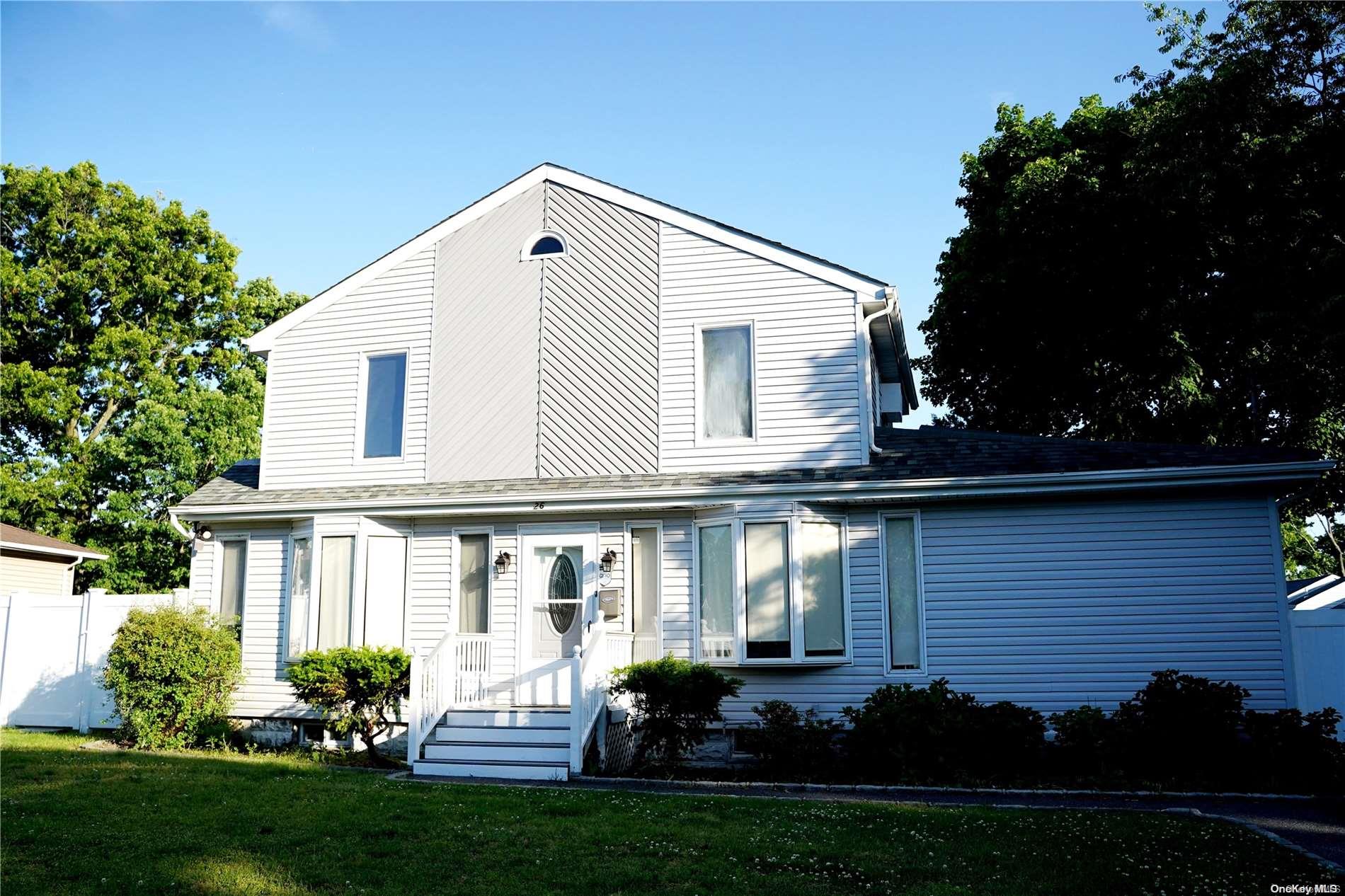 a view of a house with a yard and a garden