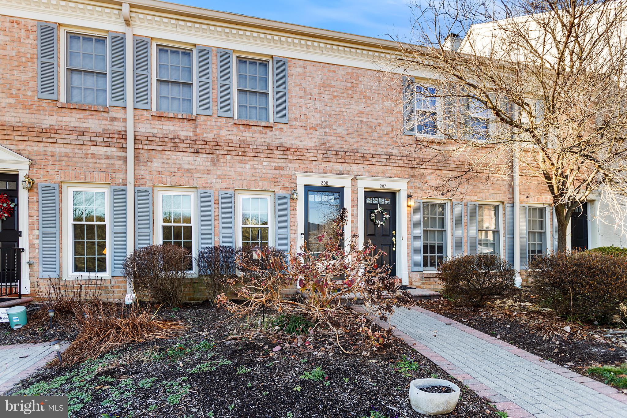 a view of a brick building next to a yard