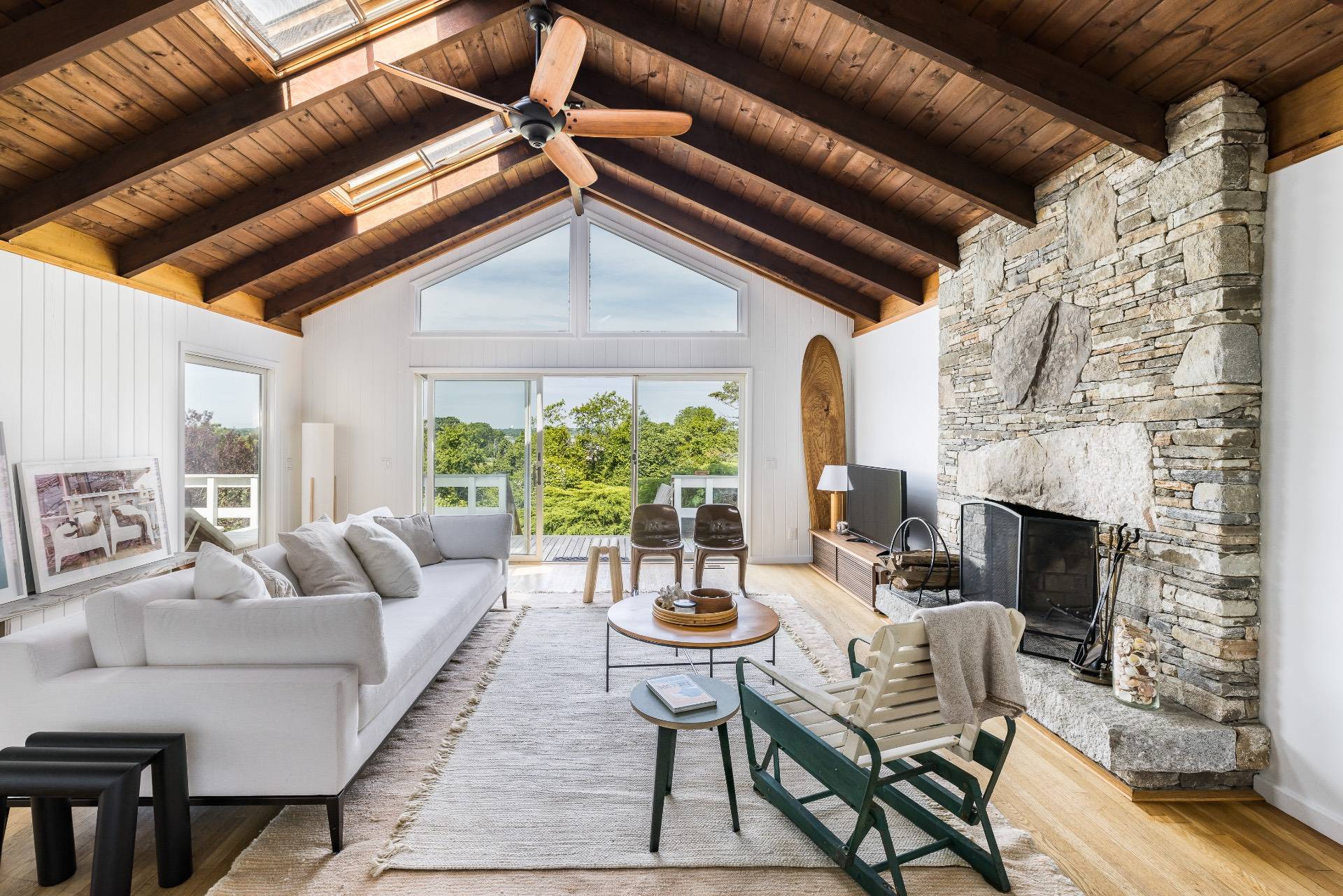 a living room with furniture a fireplace and a table