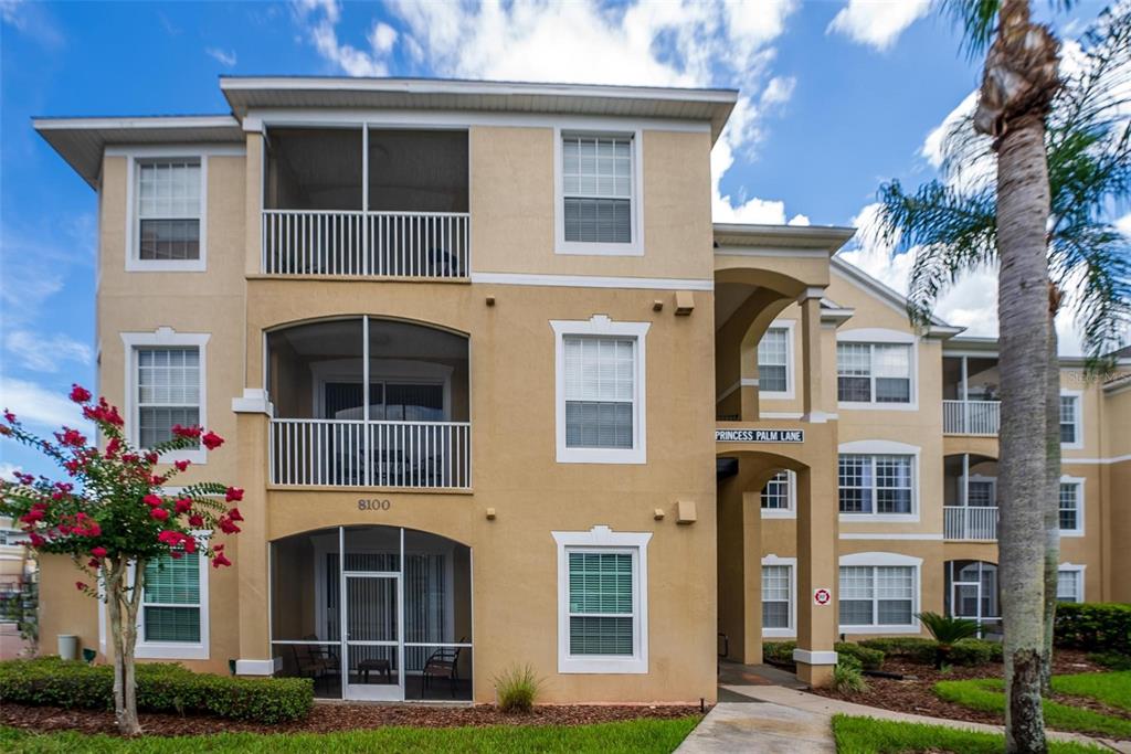 a front view of a residential apartment building with a yard