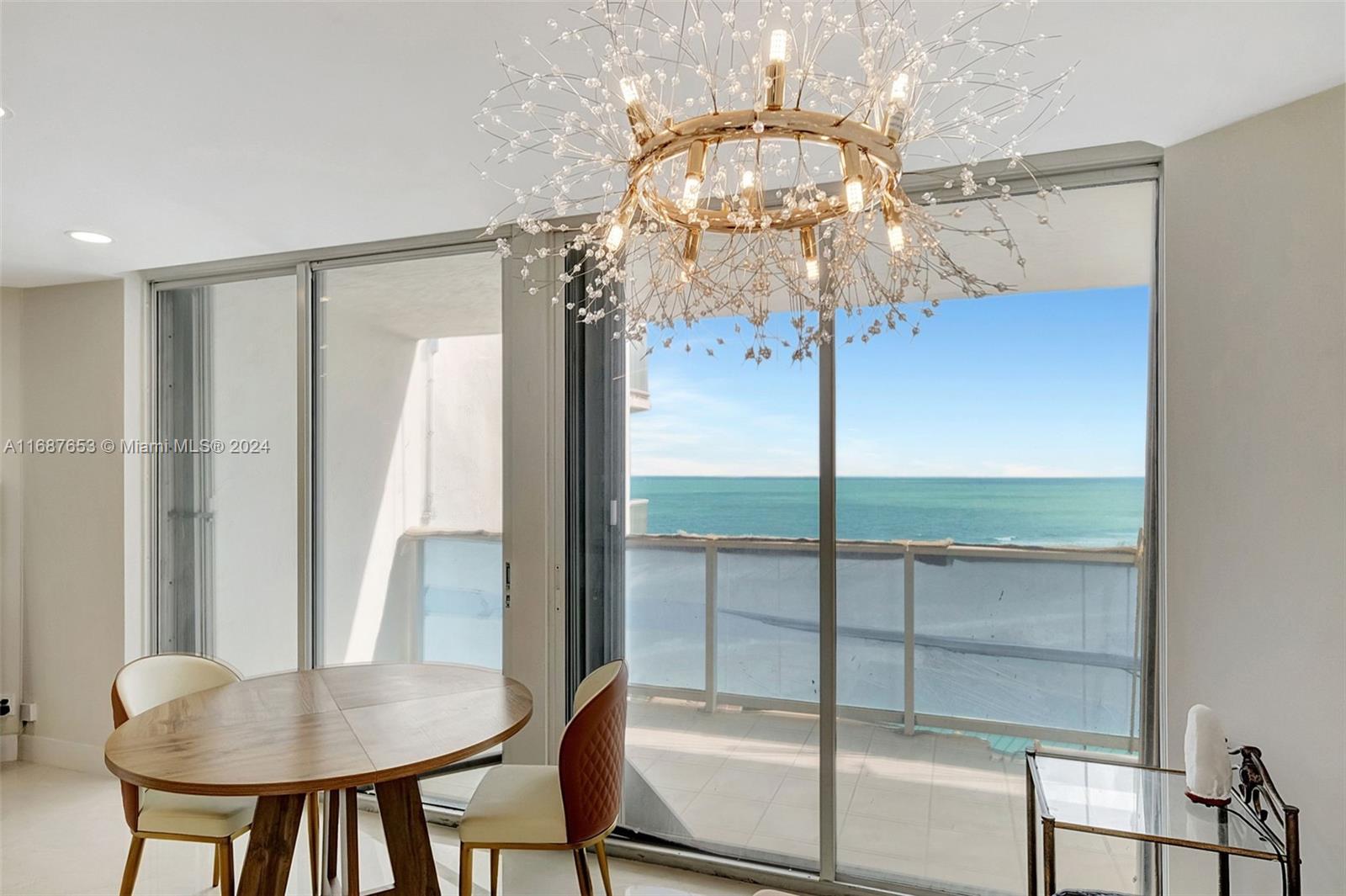 a view of a dining room with furniture wooden floor and chandelier