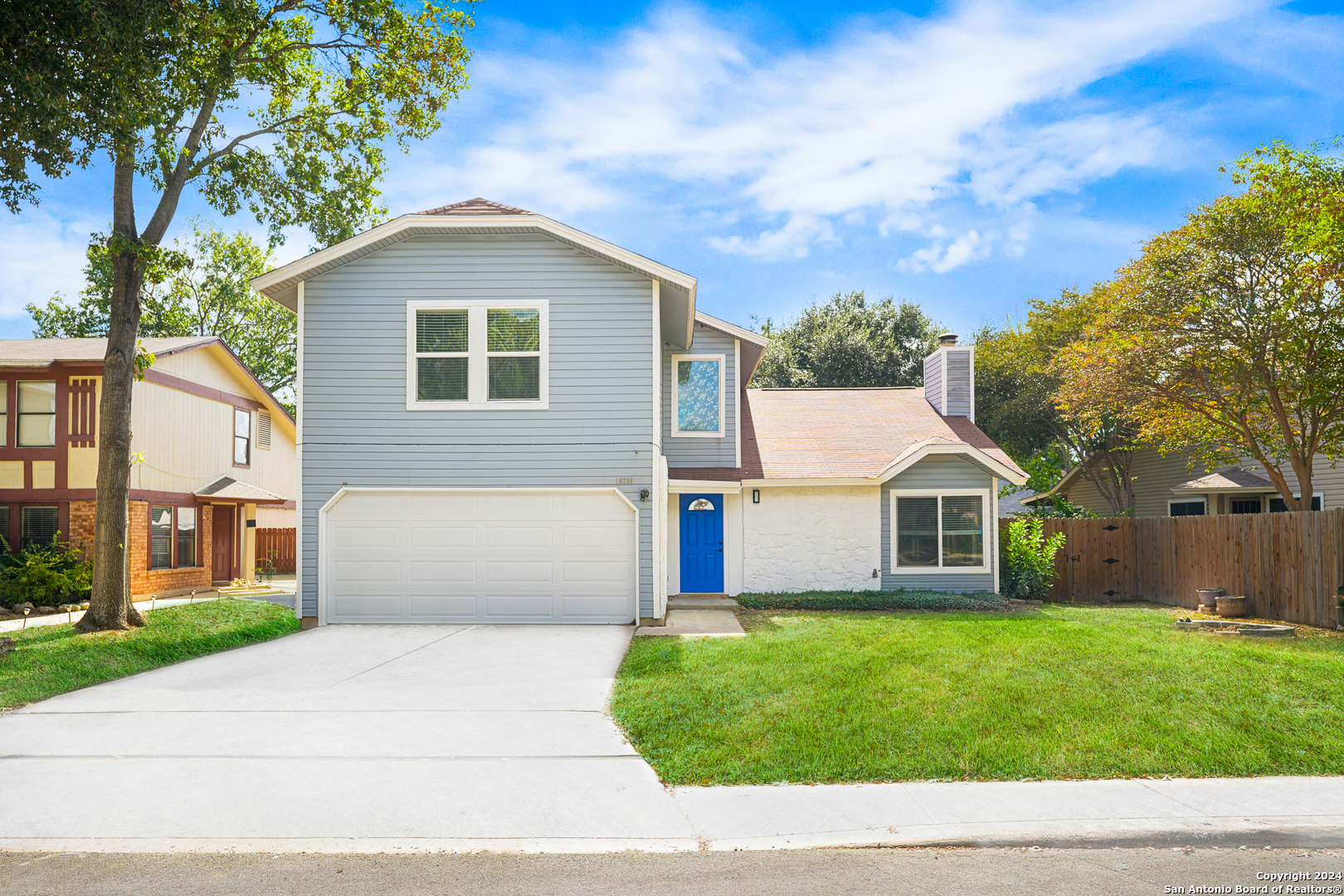 a view of house with a yard