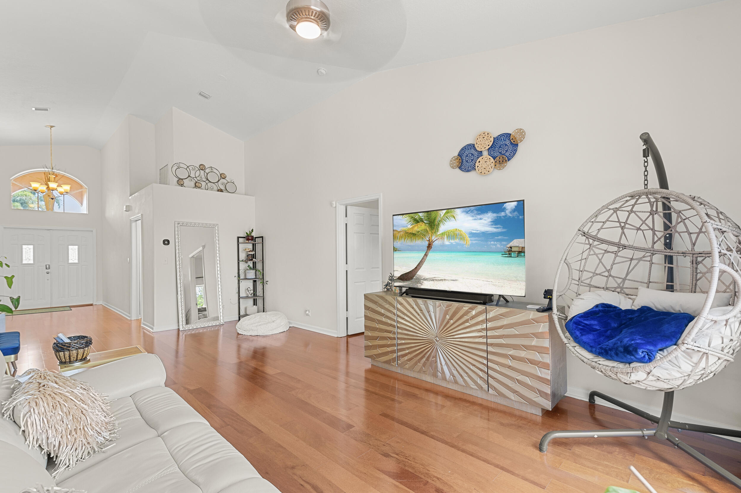 a living room with furniture and a wooden floor