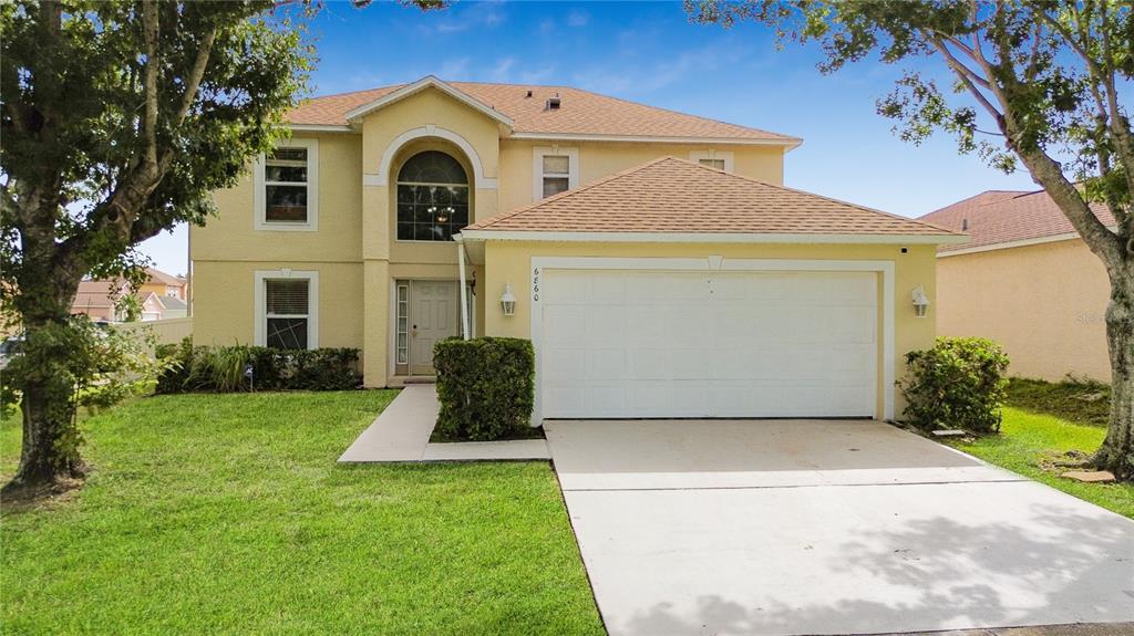 a front view of a house with a yard and garage