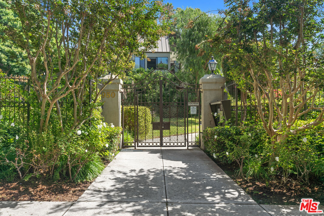 a view of a pathway of a house with a garden