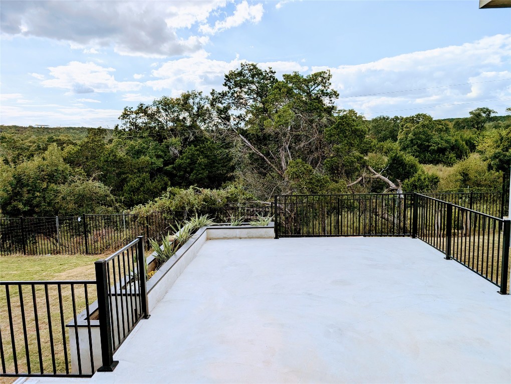 a view of balcony with wooden floor and fence