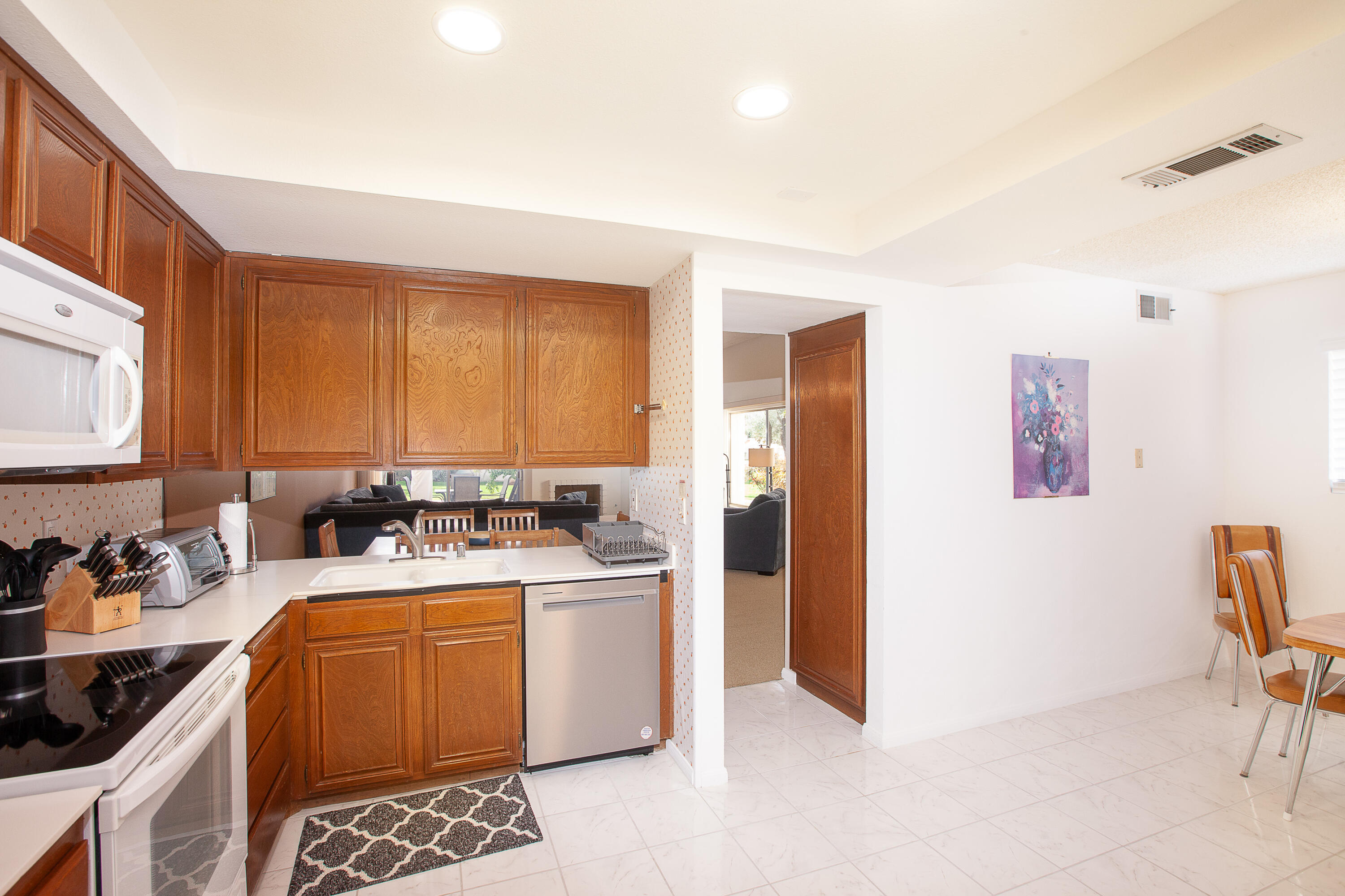 a view of a kitchen with sink cabinets and furniture