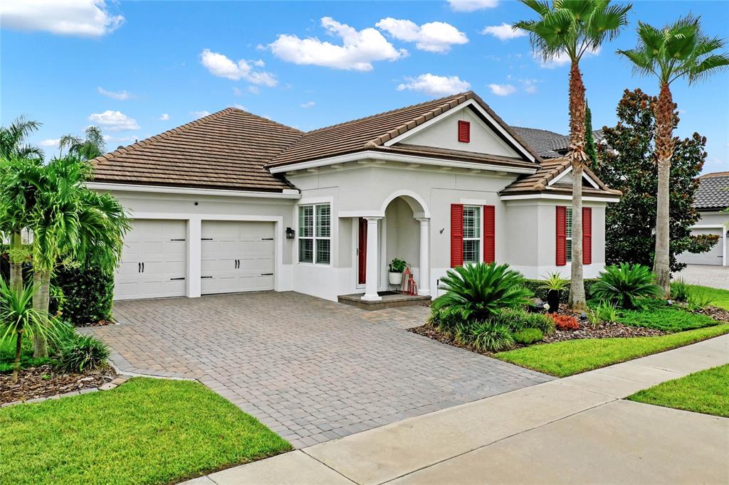 a front view of a house with a garden