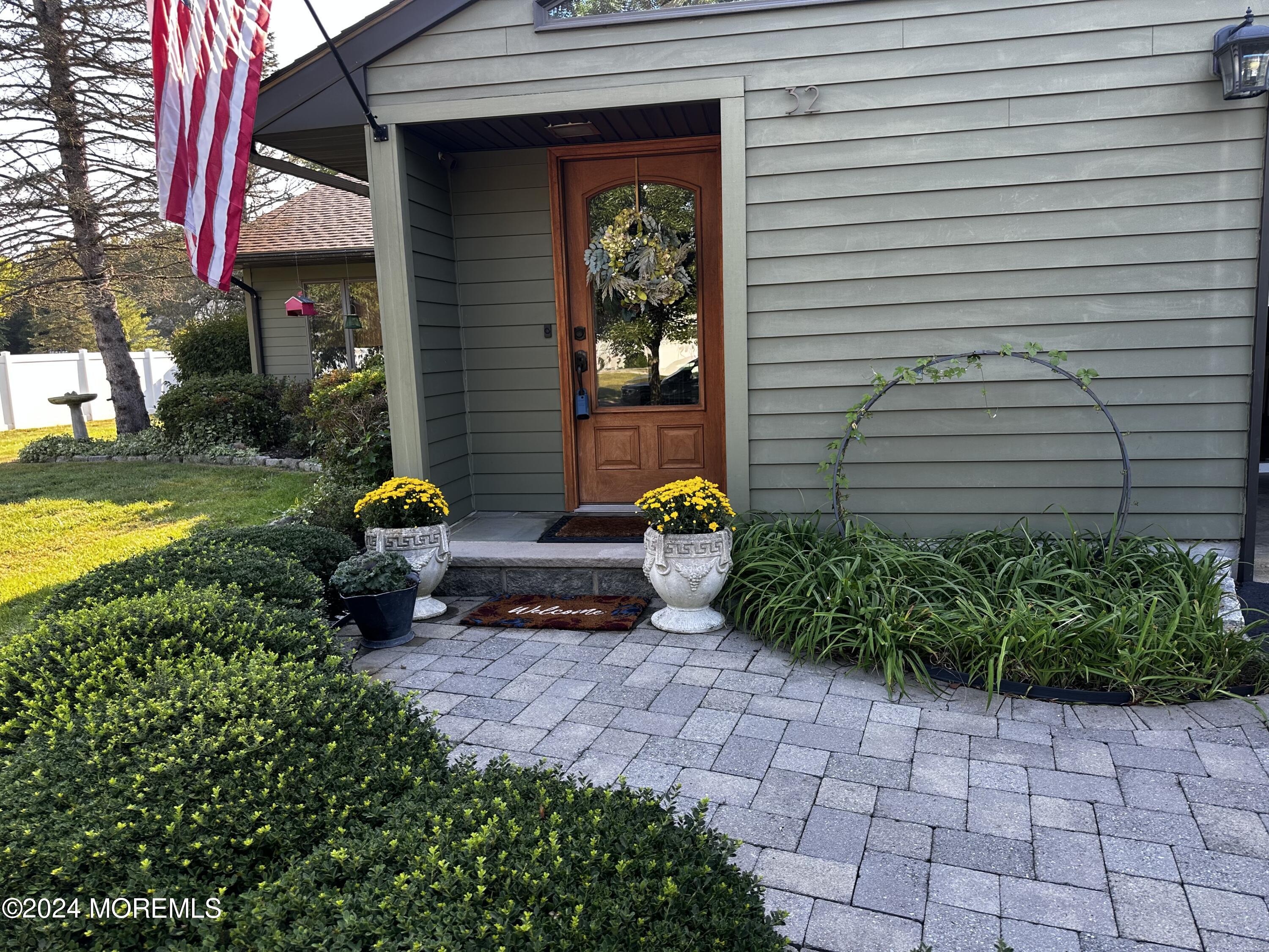 a view of a backyard with plants and a patio