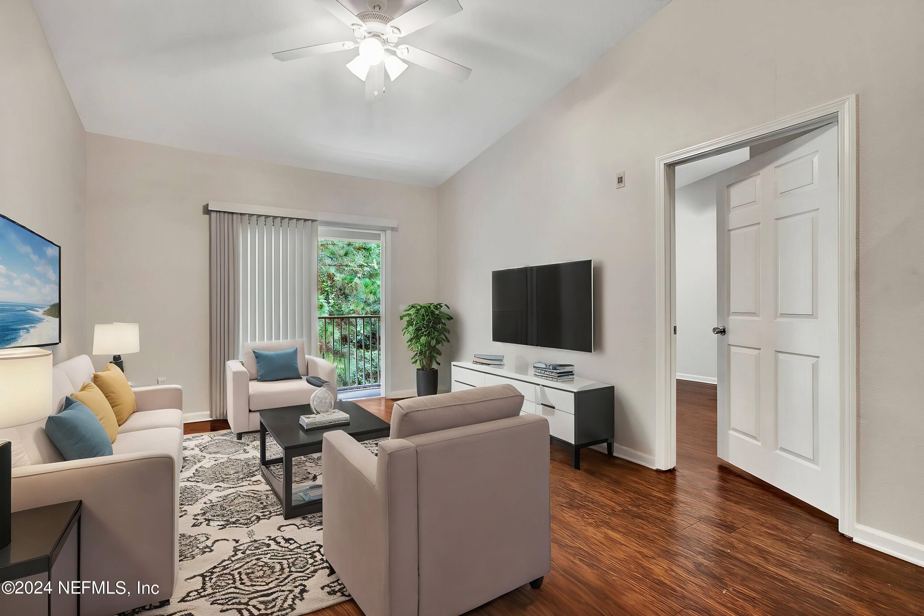 a living room with furniture and a flat screen tv