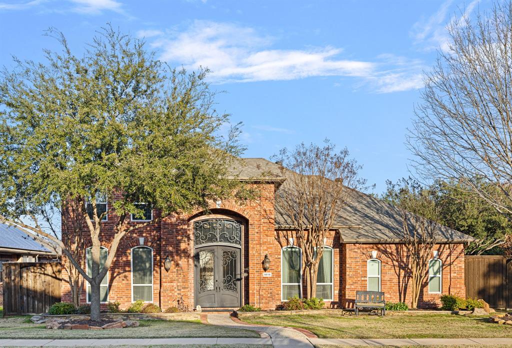 a building view with large trees and a pathway