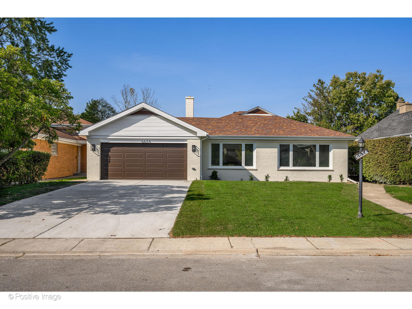 a front view of a house with a yard and a garage