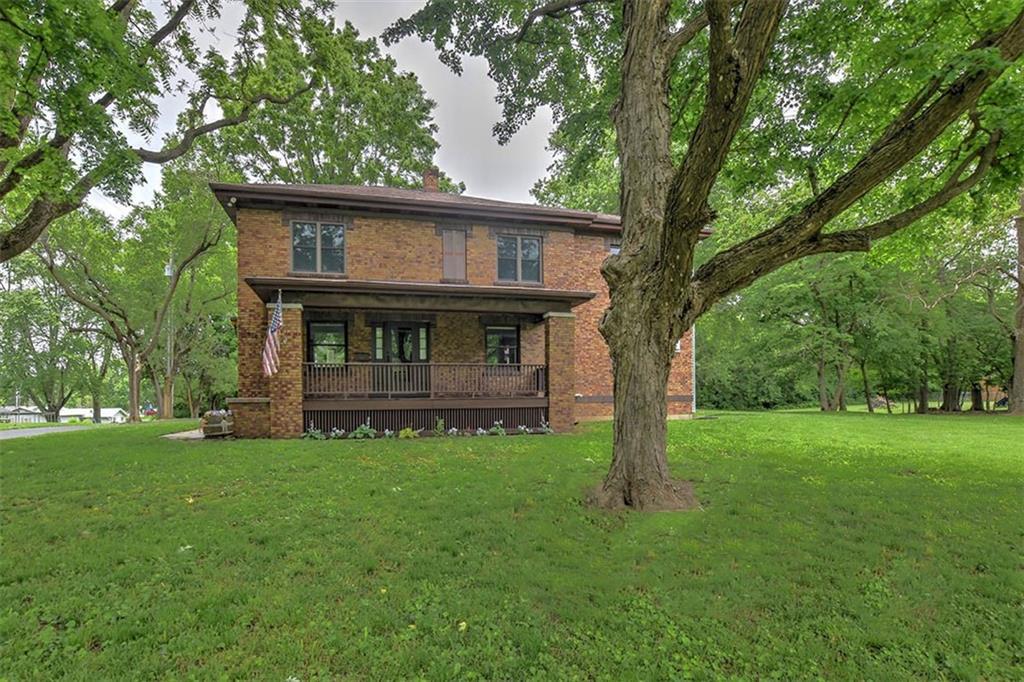 a view of backyard of house with green space