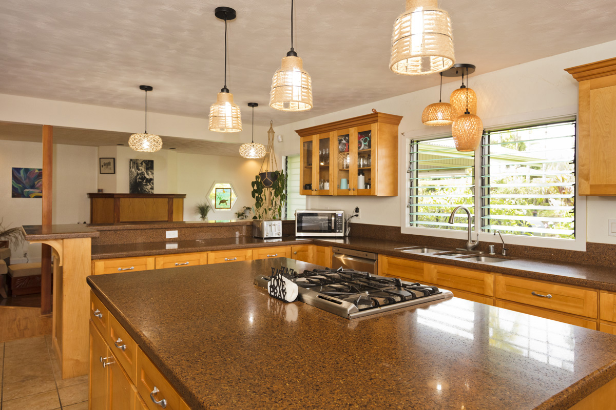 a kitchen with stove a sink and a counter top space