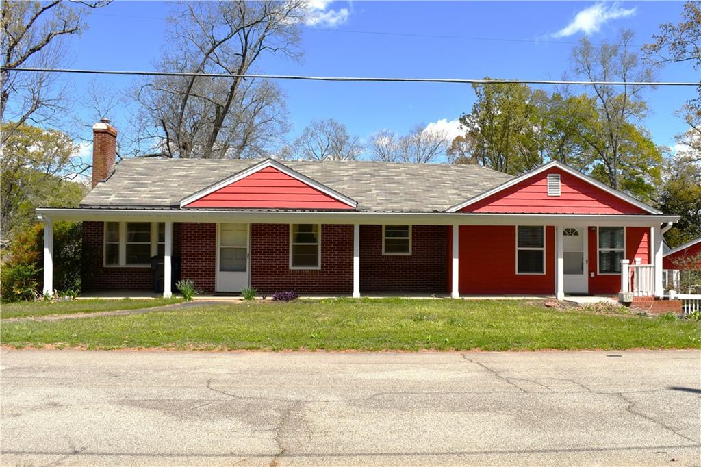 a front view of a house with garden