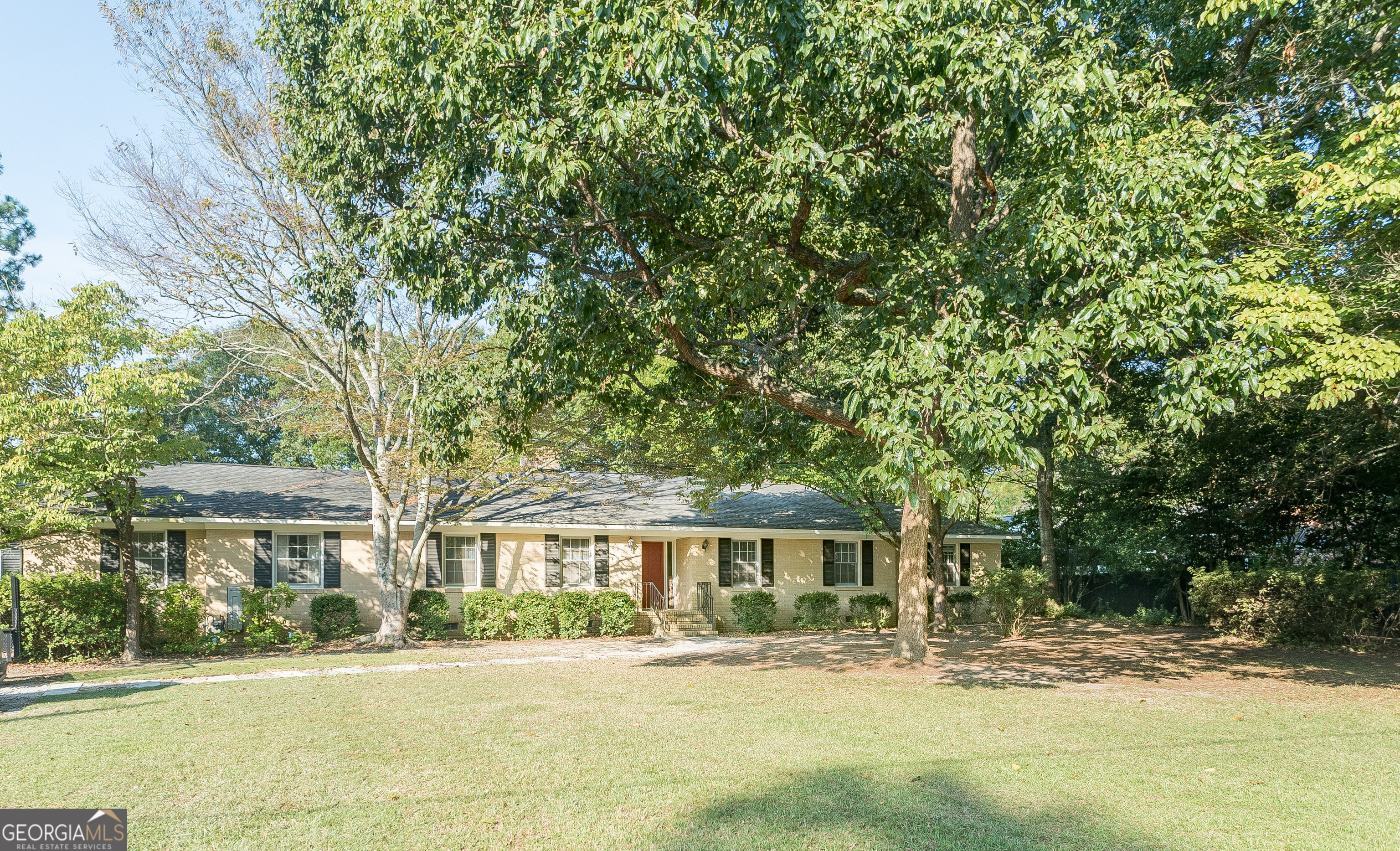 a front view of a house with a garden