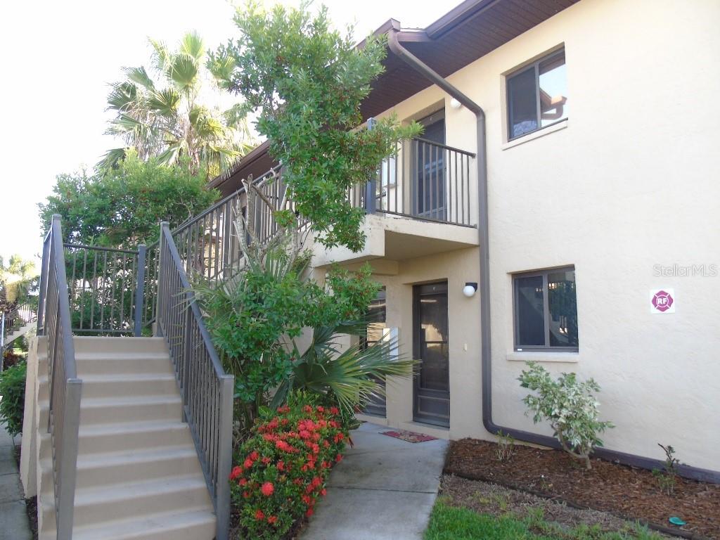 a front view of a house with plants