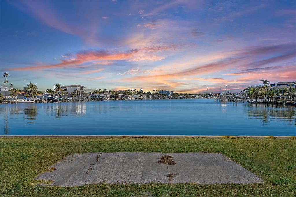 a view of a lake with houses in the back