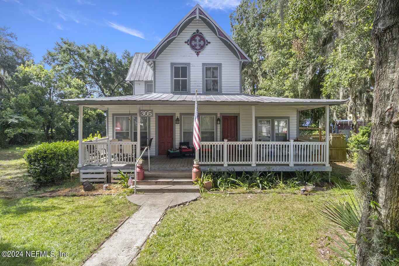 a front view of a house with garden and porch