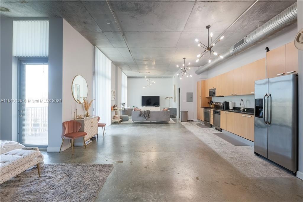 a living room with furniture fireplace and chandelier