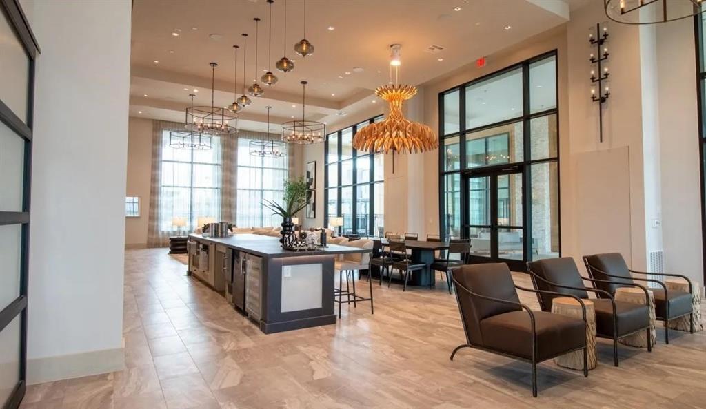 a living room with furniture a large window and wooden floor