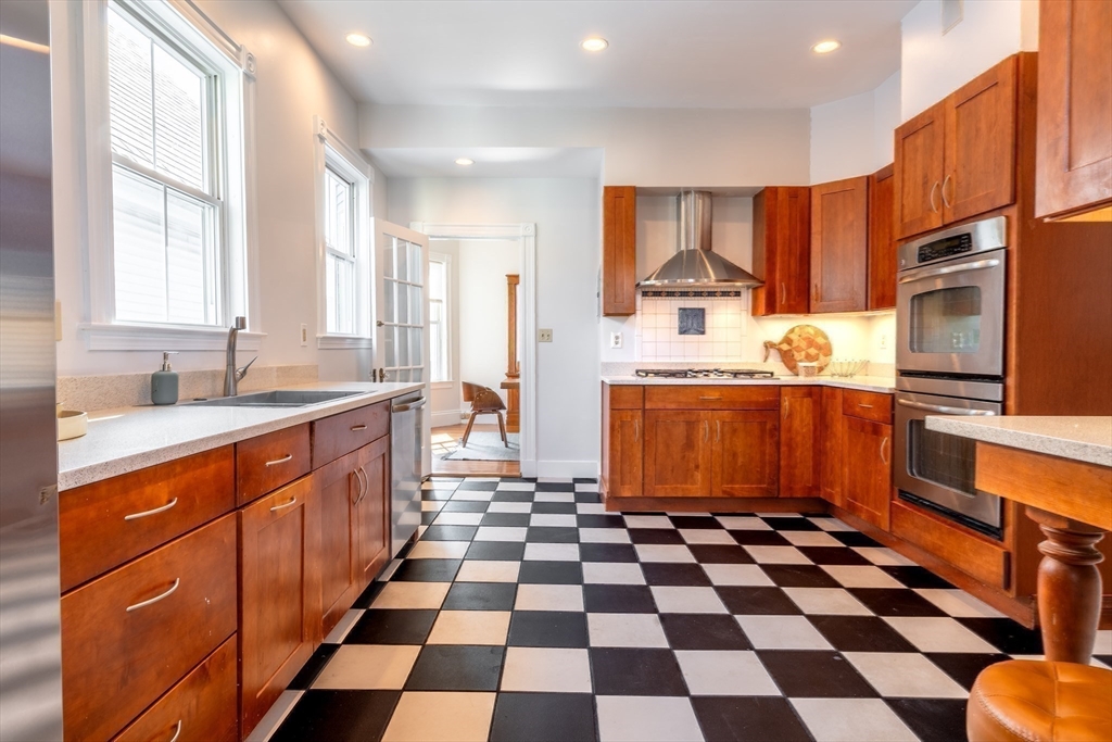 a kitchen with granite countertop stainless steel appliances a sink and a window