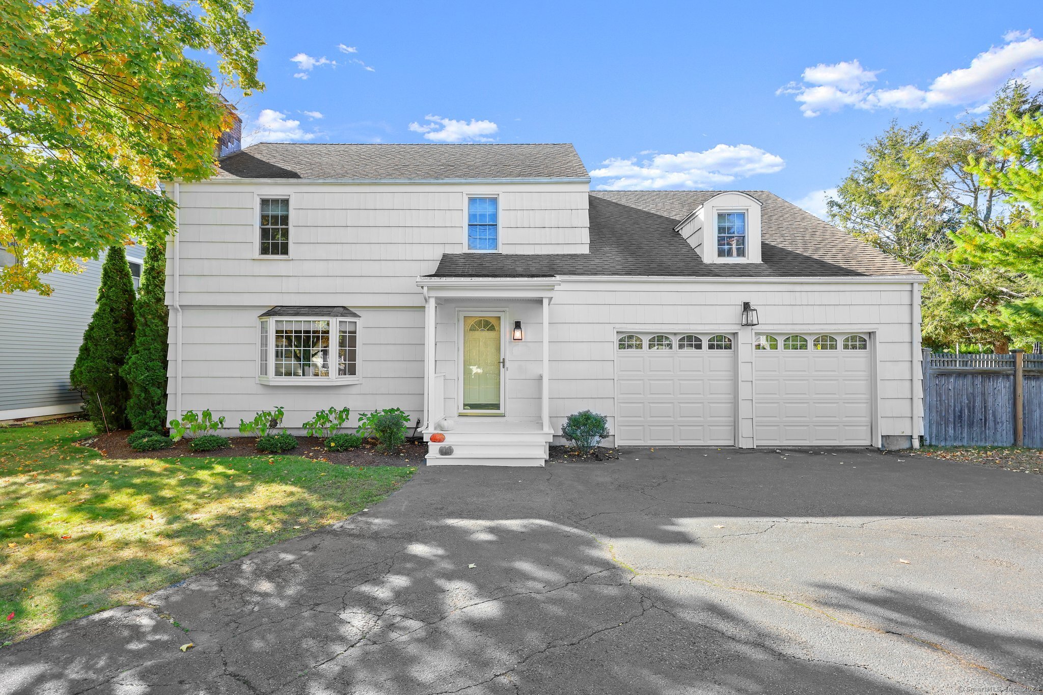 a view of a house with a yard and garage