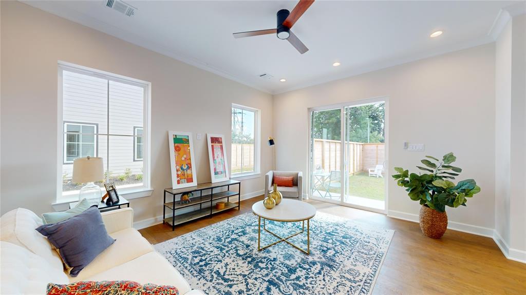 a living room with furniture flowers and a potted plant