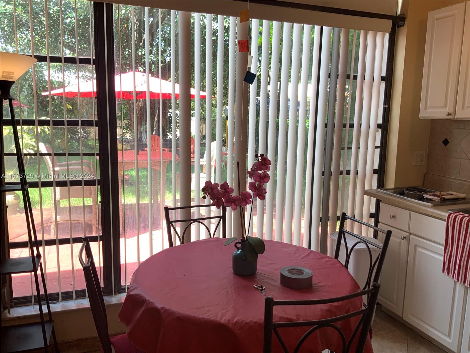 a view of a dining room with furniture and a window