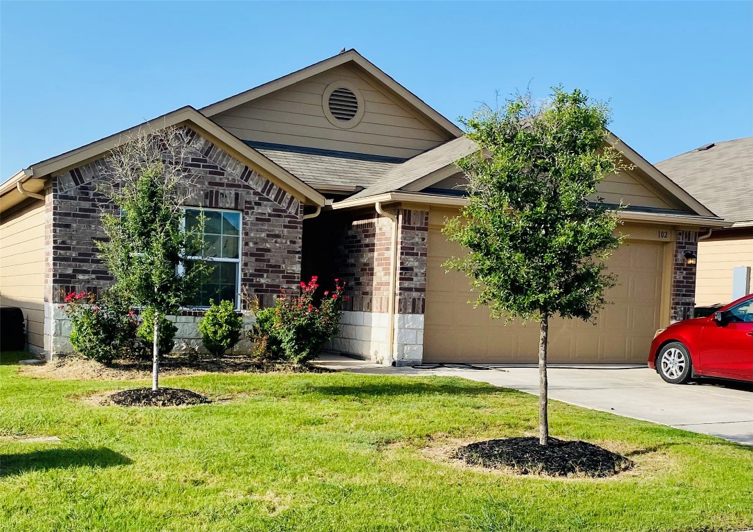 a front view of a house with a yard