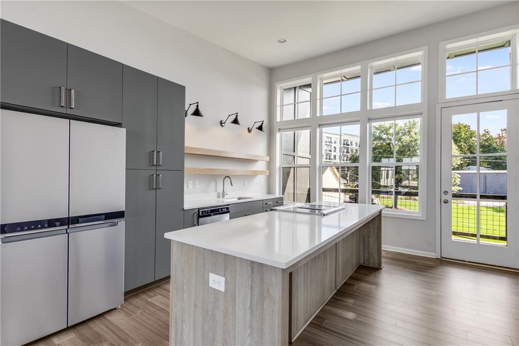 a large kitchen with a large window and refrigerator