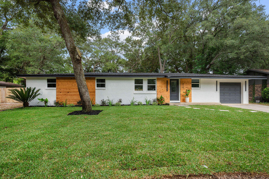 a front view of house with yard and green space