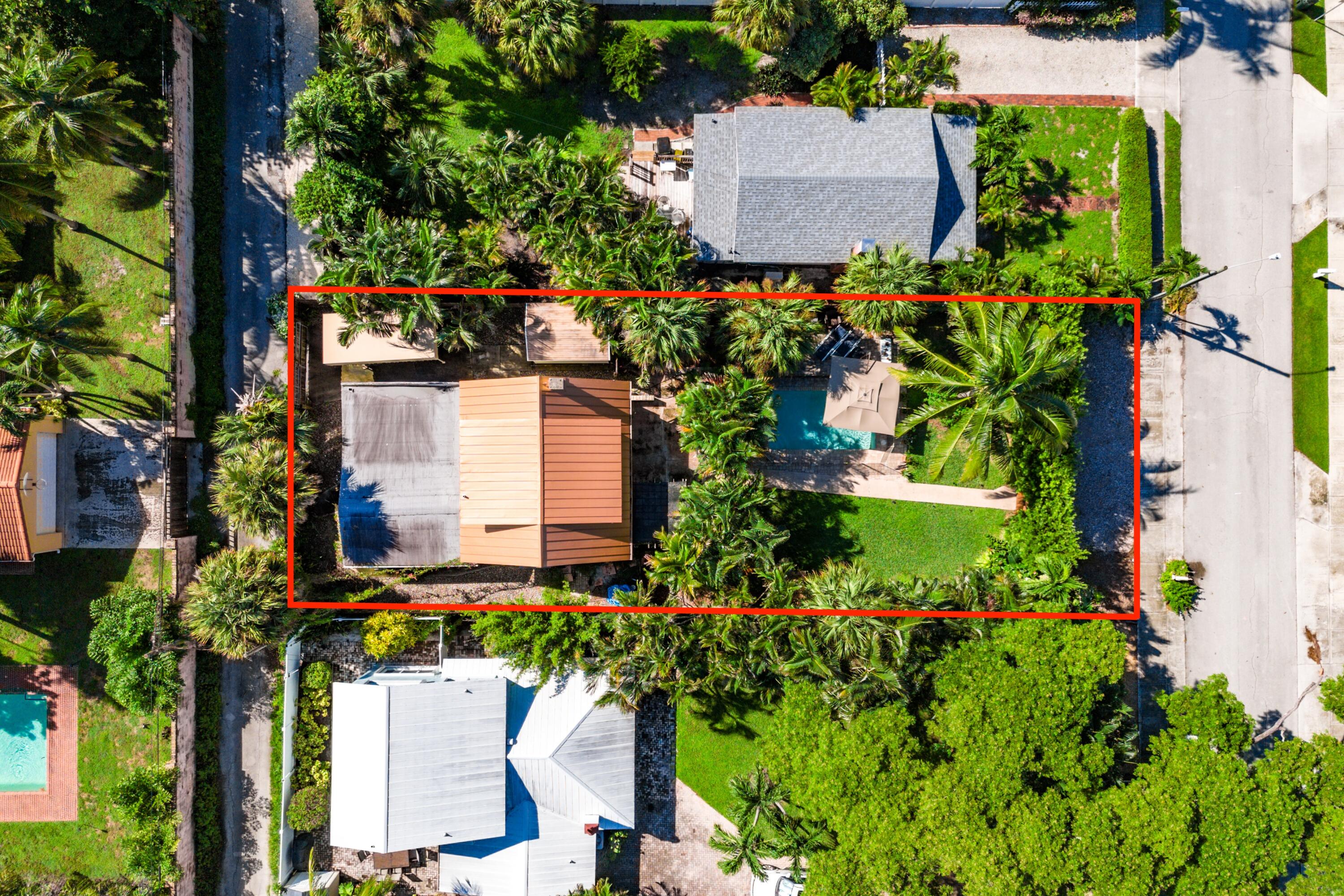 an aerial view of a house with a yard and garden