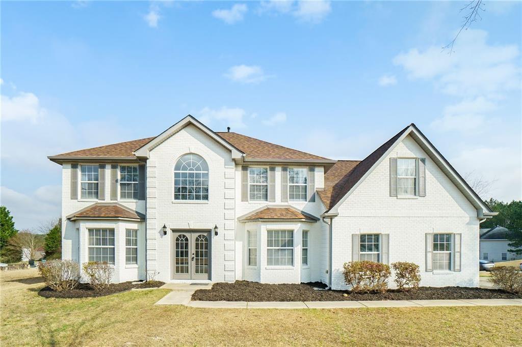 a front view of a house with a yard