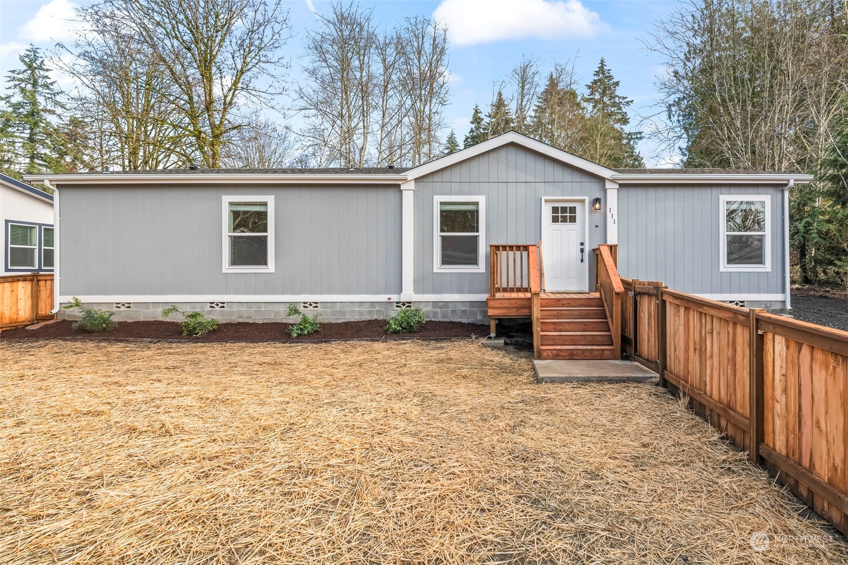 a view of a house with a yard and fence